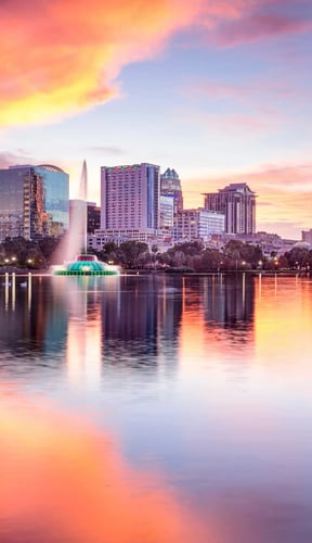 Orlando skyline at sunset reflected in Lake Eola